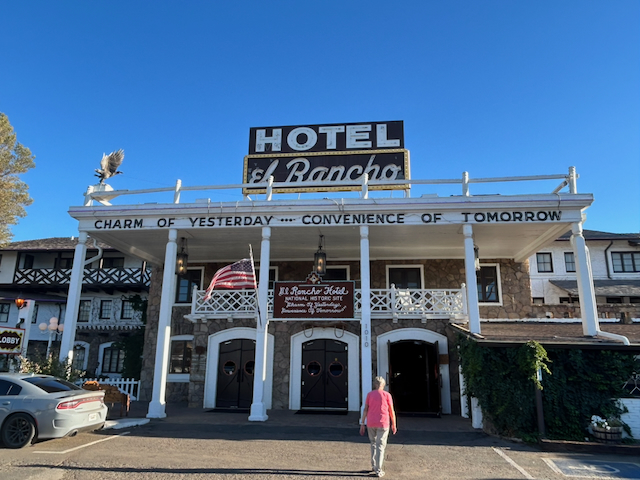 The historic white facade and rooftop sign of El Rancho Hotel