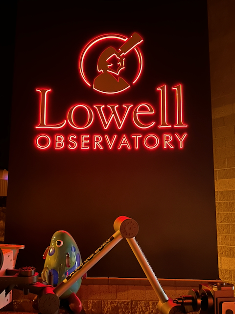 The Lowell Observatory name and telescope symbol glowing in red neon
